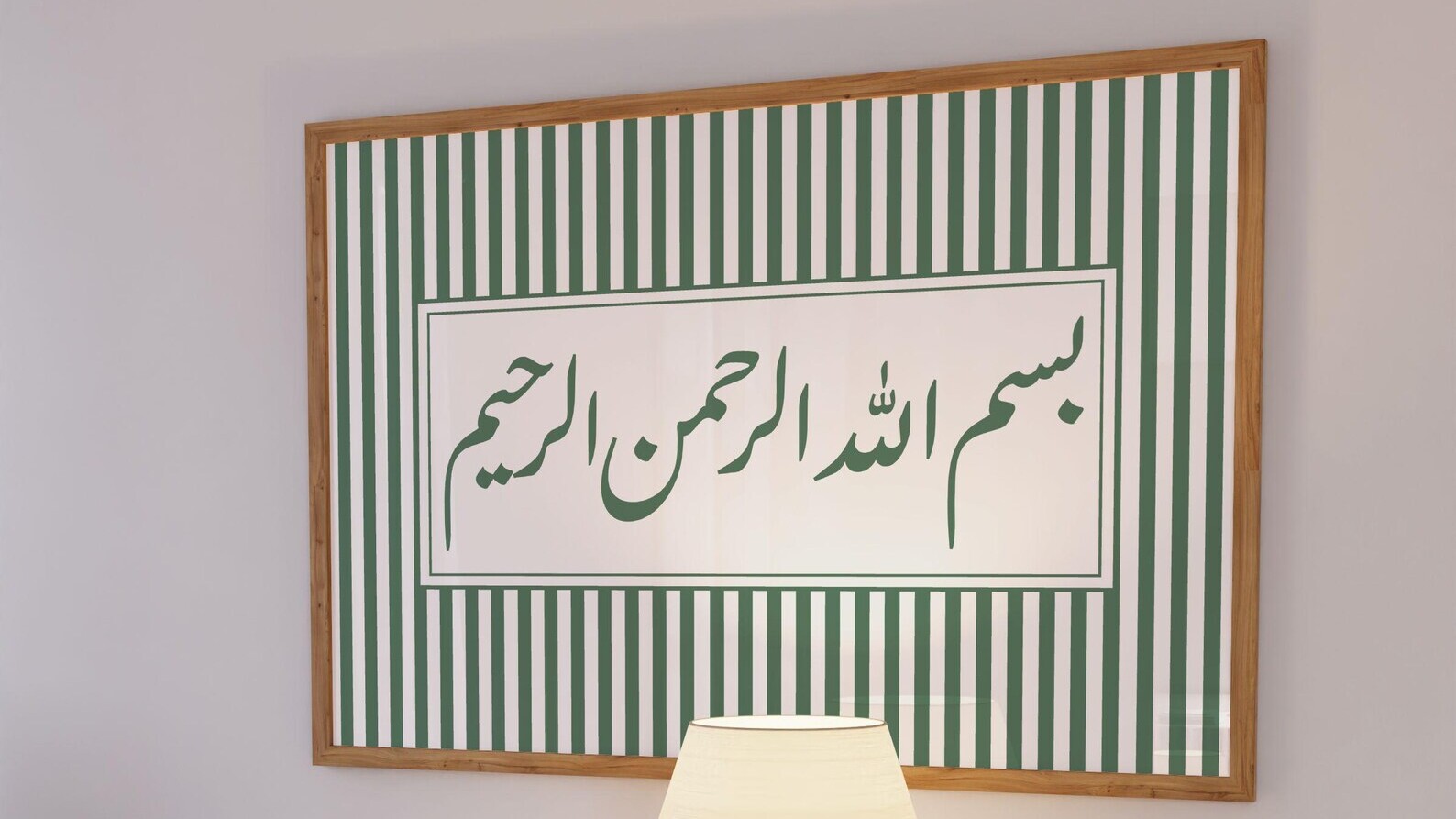 A framed print of the bismillah set in Gulzar, hanging above a dresser.